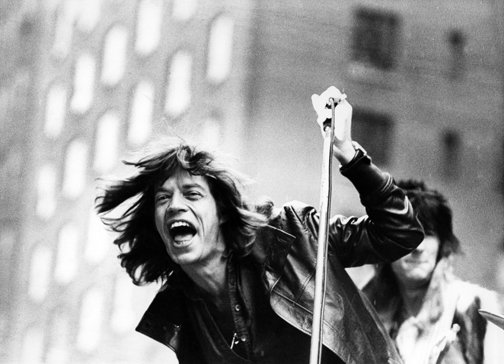 British musician Mick Jagger of the rock band the Rolling Stones performs on a flatbed truck on 5th Avenue as the band announce their 'Tour of the Americas '75,' New York, New York, May 1, 1975. (Photo by Fred W. McDarrah/Getty Images)